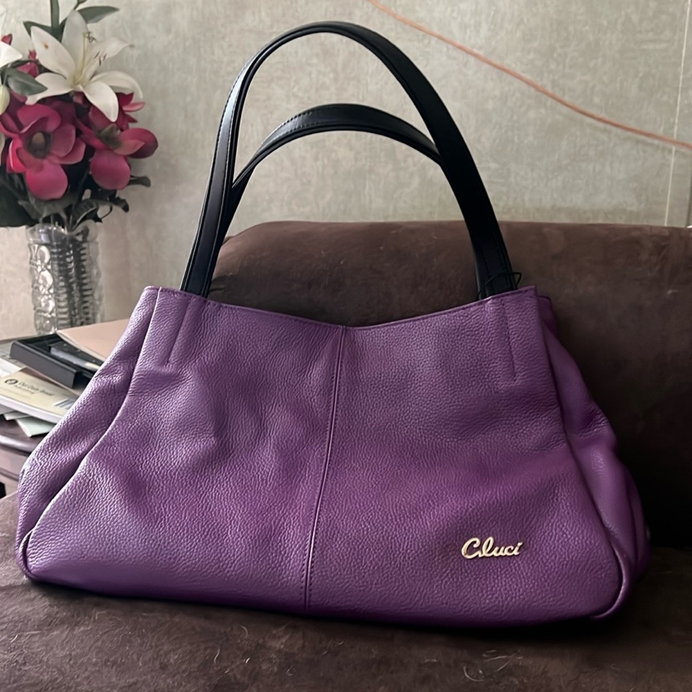 Beautiful handbag. A deep purple  in color.  15 X 9 1/2. Leather. Used once.